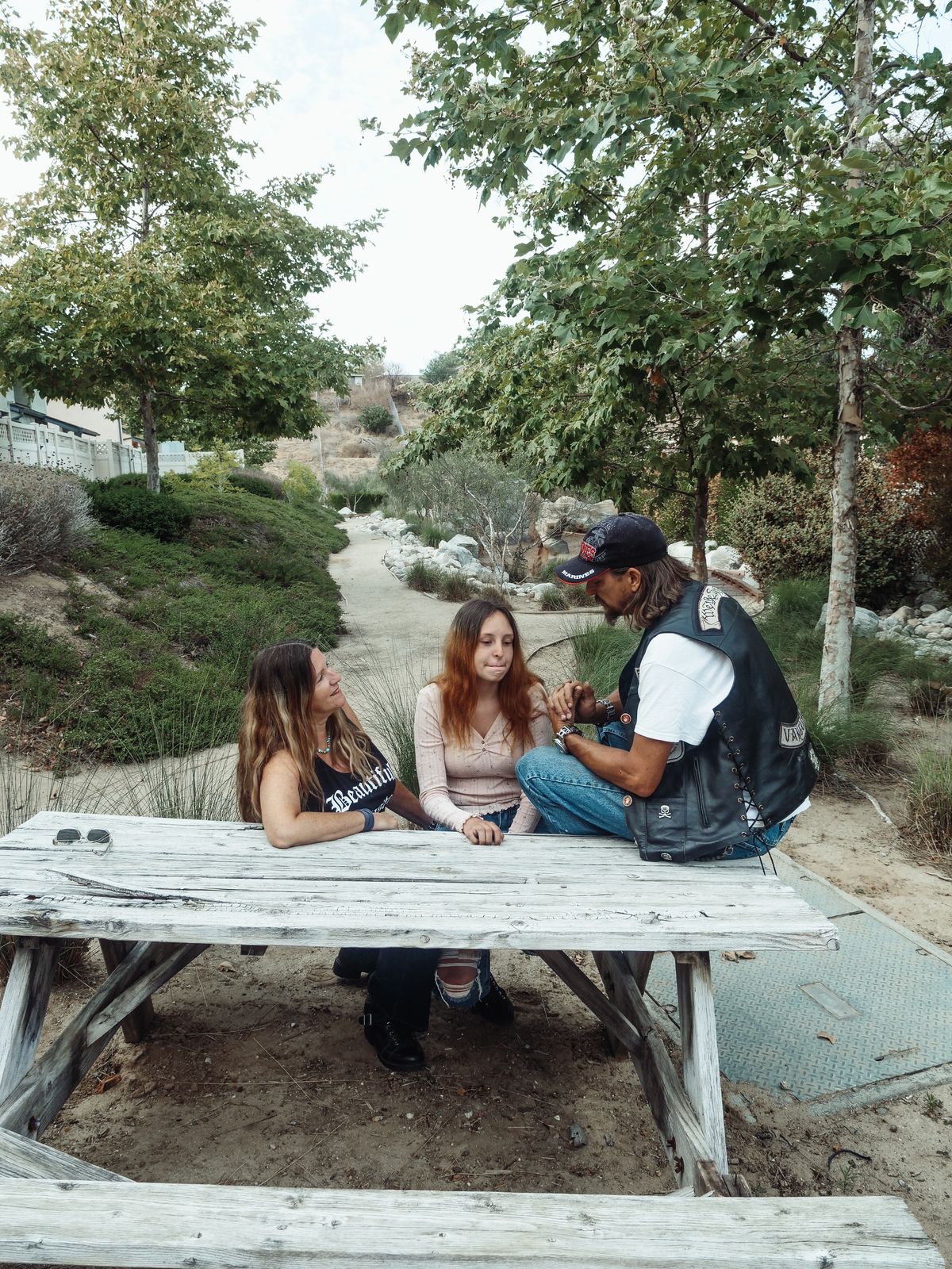 A family talking around an outdoor table.