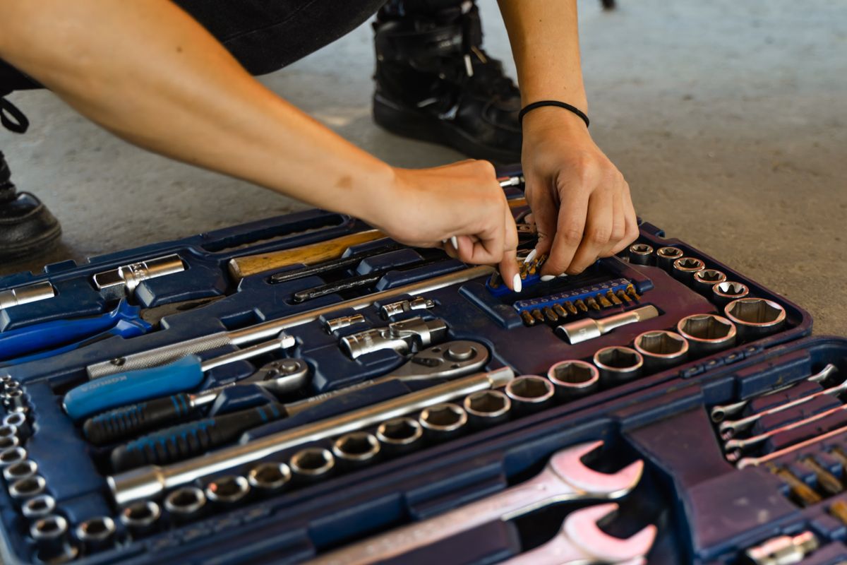 Hand tools stored together in an open toolbox.