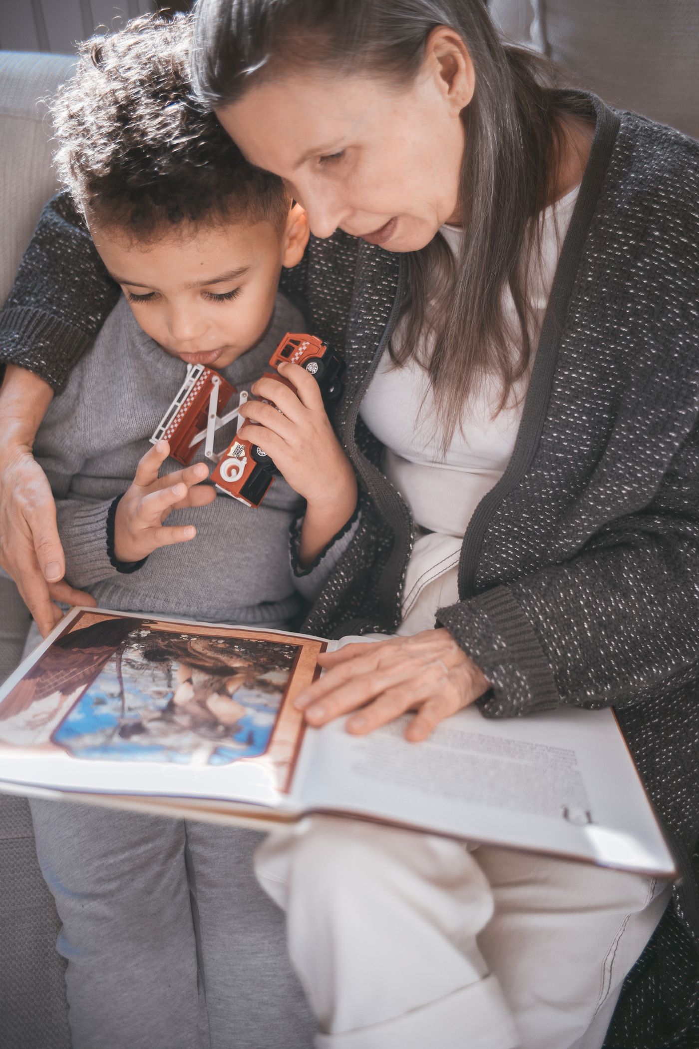 A grandmother and child reading a picture book