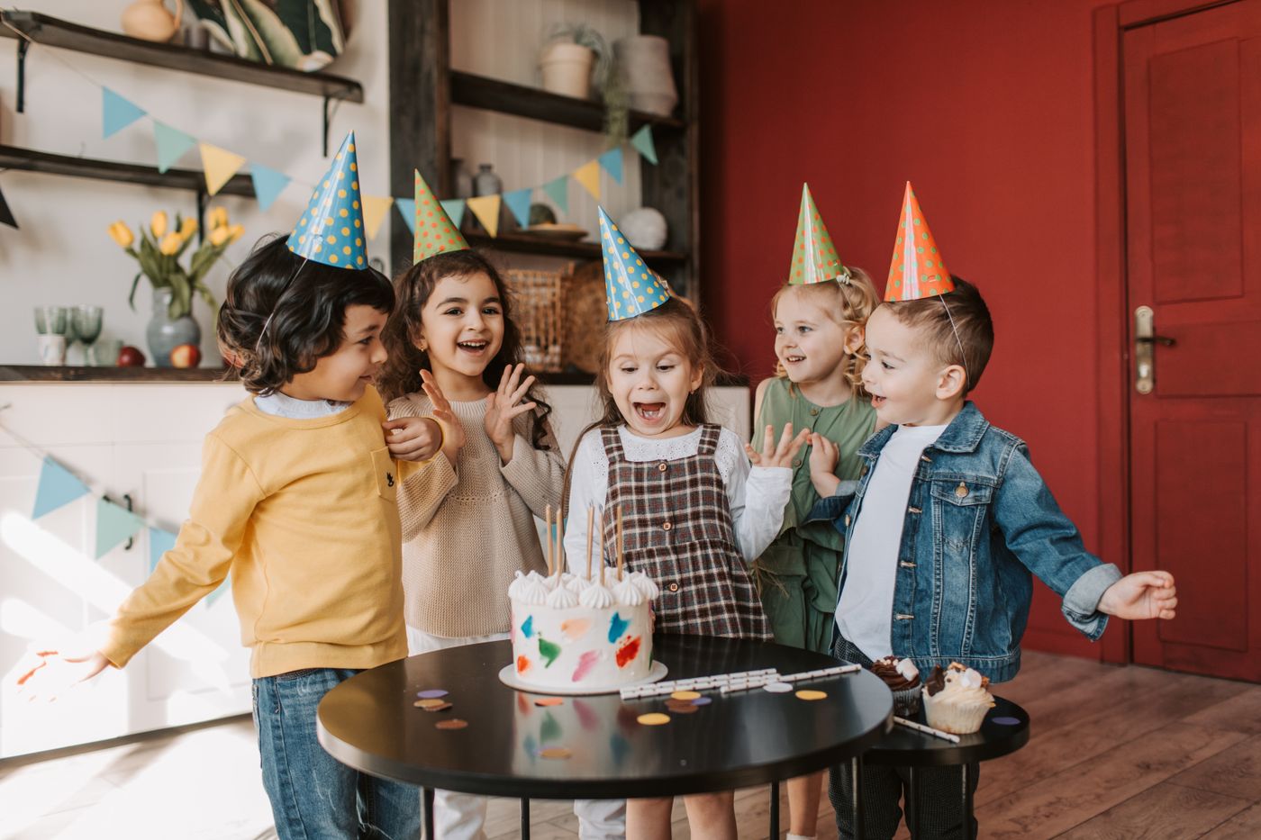 Children gathered around a birthday cake