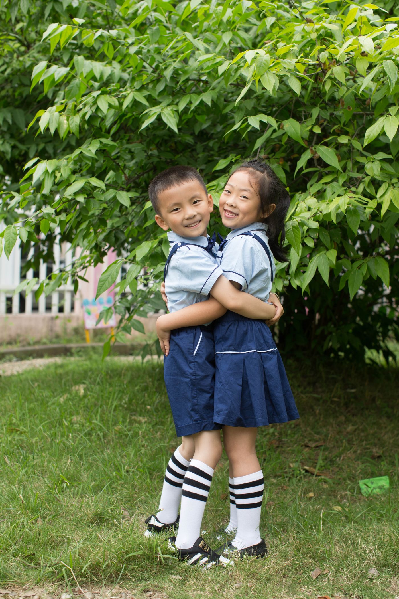 Two children hugging outdoors